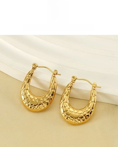 Detailed view of U-shaped 18K gold plated earrings with embossed fish scale texture