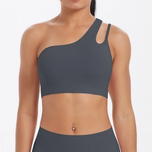 Detail of dark grey one-shoulder sports bra with cutout and high-waist yoga leggings