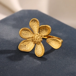 Macro view of gold flower ring featuring textured petals and a vintage frosted finish