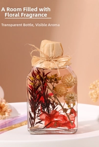 Detail of a square glass aroma diffuser bottle with preserved flowers and jute twine