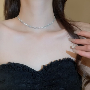 Detail of silver zircon fringe necklace worn on neck with black lace clothing