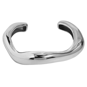 Detailed view of an irregular polished silver cuff bracelet with a sleek wavy design