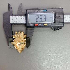 Digital caliper measuring the adjustable width of 23.3mm on a gold heart wing ring