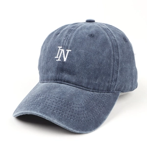Detail of navy blue washed cotton baseball cap with white IN letter embroidery