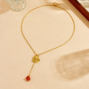 Vintage gold plated snake chain necklace featuring a 3D floral pendant and red teardrop charm