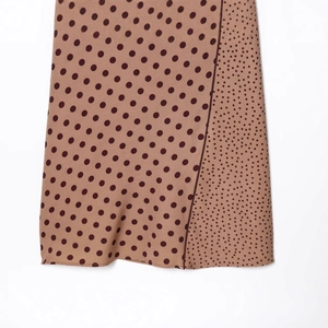 Brown polka dot midi dress with spliced patterns and smooth fabric drape detail
