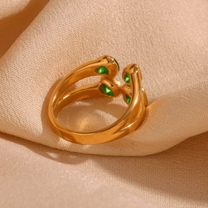 Detail of 18K gold-plated double-layer ring with green drop zircon on silk fabric
