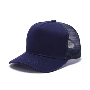 Detailed close-up of navy blue cotton trucker hat with breathable mesh and curved brim
