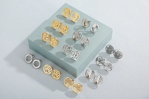 Collection of various hollow stainless steel stud earrings in gold and silver finishes