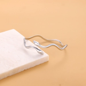 Detail shot of a silver serpent cuff bracelet featuring a sleek open adjustable design