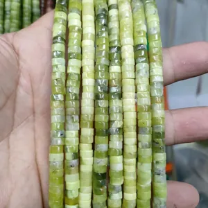 Close-up of natural green jade cylinder beads showing detailed stone texture and veins