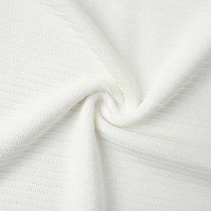 Detailed macro view showing the premium ribbed texture of white knitted fabric for summer set
