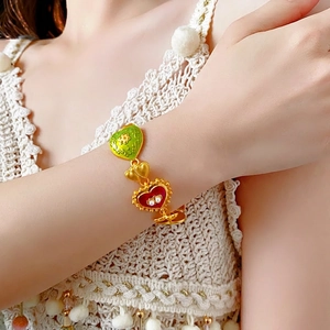 Vintage gold heart charm bracelet with green enamel flower and pearl details