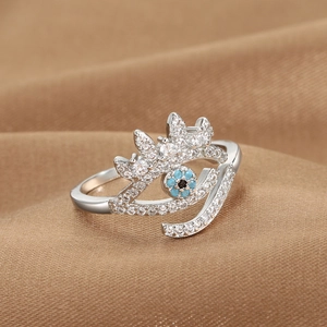 Silver evil eye open ring with crown design featuring blue and white zircons