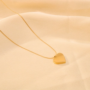 Minimalist 18k gold plated stainless steel necklace with 3D heart pendant on fabric