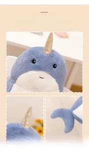 Detailed view of plush narwhal toy with golden glitter horn and soft blue fabric