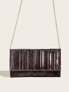 Detail of purple pleated evening clutch bag with fine texture and gold metal chain strap