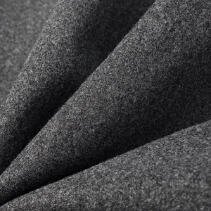Macro shot of grey wool fabric texture showing thick felt fibers and soft material folds
