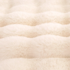 Plush faux fur blanket with warm cream wavy texture and ultra-thick thermal design