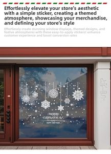 Close-up of white snowflake window stickers with Merry Christmas text on glass shopfront