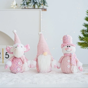 Detail of pink Christmas gnome and reindeer plush toys with sequins and faux fur texture