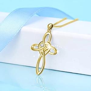 Detail showing the intricate golden Celtic knot cross pendant on a matching box chain