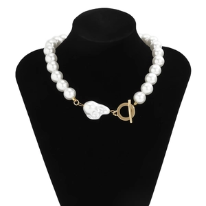 Detail of large white pearl necklace with baroque pendant and golden OT toggle clasp