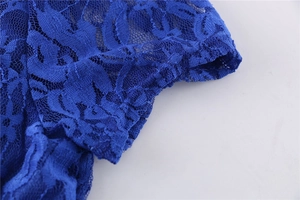 Close-up of royal blue lace embroidery showing intricate hollow textures and fine stitching
