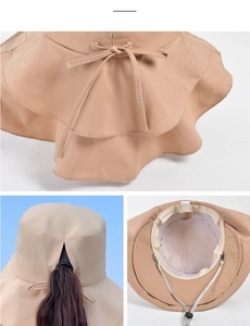 Detail view of khaki sun hat with wide layered brim, ponytail hole and bow back design