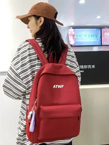 Red canvas backpack with ATWF logo and purple SPACE TRAVEL ribbon for casual travel
