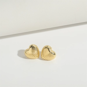 Minimalist gold heart stud earrings featuring a radiant textured shell pattern design