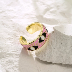 Pink enamel evil eye adjustable ring in 18K gold plated copper on white stone stand