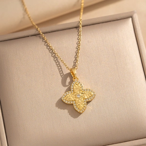 Elegant gold clover necklace with white zircon pavé setting in a premium jewelry box
