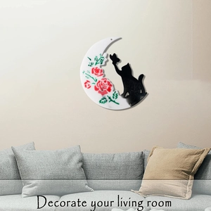 Macro detail of moon and cat wall art decor showing floral patterns and butterfly silhouette