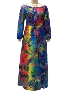 Detail of vibrant rainbow gradient dress with ornate golden baroque pattern and silk texture