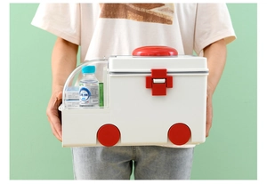 Detail showing the portable handle and ambulance-shaped white plastic first aid box