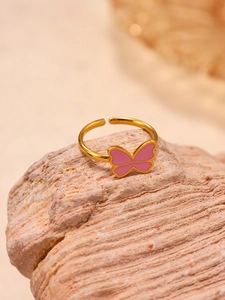 Close-up of golden adjustable ring featuring a cute pink enamel butterfly detail