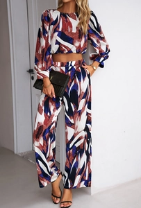 Detail of burgundy and blue abstract print on long-sleeve crop top and wide-leg trousers