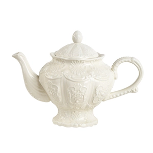 Vintage cream ceramic teapot with embossed floral details and classic shell texture
