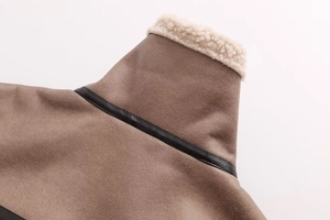 Detailed close-up of coffee brown suede jacket with cream faux fur collar and leather trim