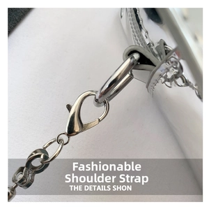 Detail of silver metallic bag strap with lobster clasp and shiny metal chain links