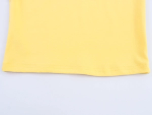 Detailed close-up of a yellow knitted t-shirt hem with professional double-needle stitching