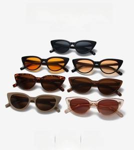 Detailed stack of various colored cat-eye sunglasses showcasing luxury frames and hinges