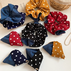 Close-up of polka dot hair scrunchies with metallic logo and trendy fabric texture