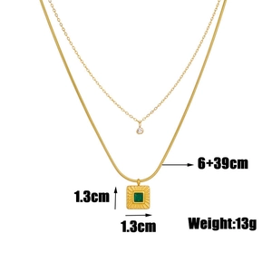 Detail view of double-layered gold necklace with square green gemstone and size specs