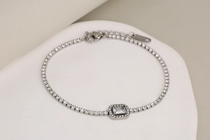 Macro view of silver bracelet with dense white zircons and a rectangular center stone