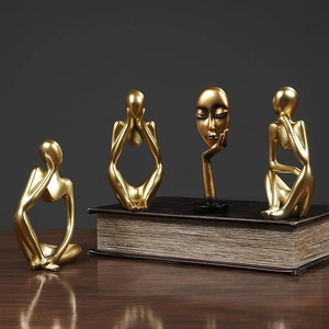 Set of four golden Nordic abstract thinker sculptures in various poses for home decor