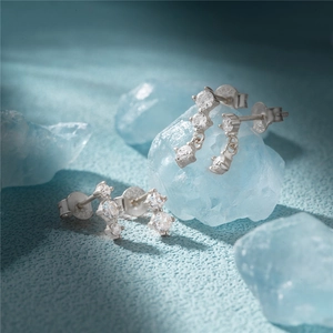 Detailed shot of S925 sterling silver stud earrings with zircons on blue crystal stone