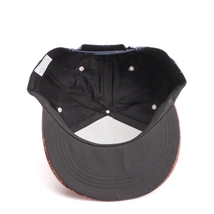 Detail of cotton baseball cap interior with snapback closure and washing label