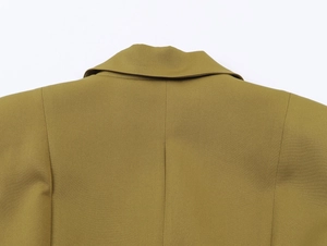 Detail view of the stitching on shoulder and collar of this mustard yellow blazer